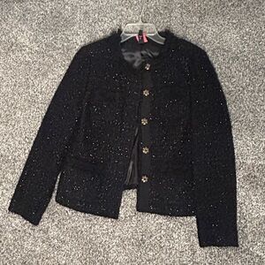 Tweed jacket in black, Size 12P. Beautiful black accents on pocket. Dry cleaned